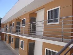 an apartment building with balconies and railings