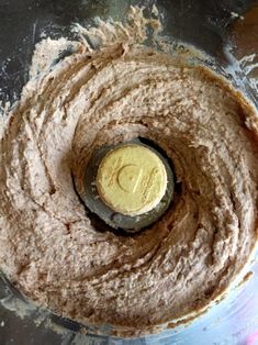 a food processor filled with some kind of brown substance in it's bottom bowl