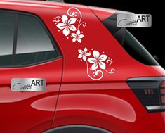 the side view of a red car with white flowers on it's decal