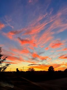 the sky is filled with pink and blue clouds