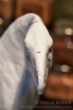 a white bird statue sitting on top of a table