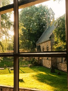 an old church is seen through the window