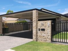 a house with a black gate and brick walls