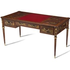 an antique desk with red leather top and gold trimmings on the legs, against a white background