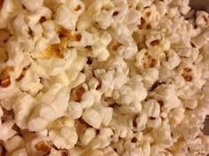 a bowl filled with popcorn sitting on top of a table