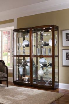 a living room filled with furniture next to a window covered in pictures and framed photos