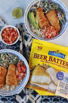 two bowls filled with fish and rice next to a bag of beer batters on a table