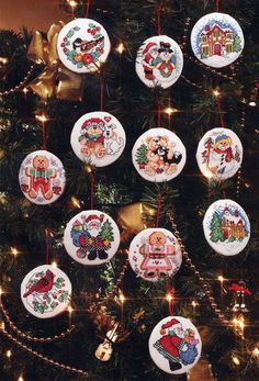 a christmas tree with ornaments hanging from it's branches and the words cross stitch ornament kits