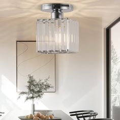 a dining room table with chairs and a chandelier hanging from it's ceiling