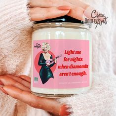 a woman holding a jar of white candles with pink background and text on it that reads light me for rights when diamonds aren't enough