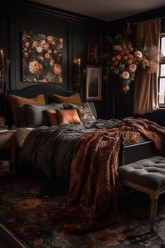 a bedroom with black walls and floral paintings on the wall, an upholstered bed