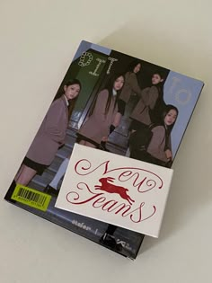 a book with an image of two young women on the front and back cover, sitting on top of a table