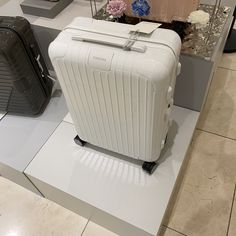 two pieces of luggage sitting on display in a store