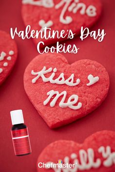 valentine's day cookies with the words kiss me on them and an empty bottle