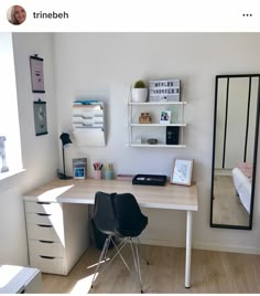 a bedroom with a desk and mirror in it