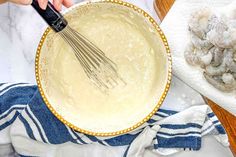 a person whisking batter into a bowl