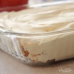 a cake in a glass dish sitting on a counter