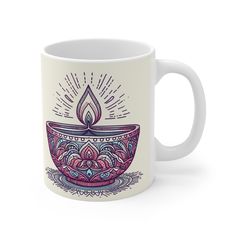 a coffee mug with a lit candle on the inside and an ornate pattern around it