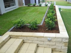 an outdoor garden with steps leading up to the house