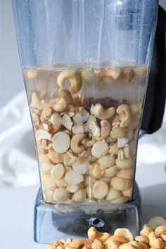 a blender filled with nuts sitting on top of a counter