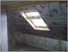 an unfinished room with a skylight and wall paper on the walls that are under construction