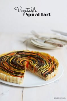 a colorful swirl tart on a white plate