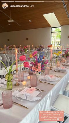 a table set with flowers and candles for a formal dinner or party in a restaurant