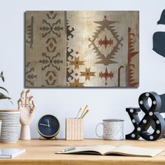 a wooden table topped with lots of different types of art on it's walls