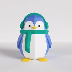 an origami penguin with a green scarf and hat on it's head