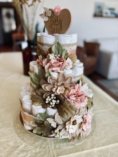 a three tiered cake decorated with flowers and hearts