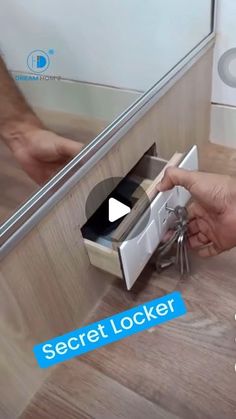 a person opening a drawer with keys in it