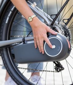 a close up of a person's hand on the handlebars of a bicycle