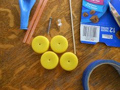 the supplies needed to make this craft include scissors, tape and buttons