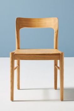 a wooden chair sitting on top of a white table