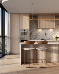 a modern kitchen with marble counter tops and wooden cabinetry, along with two bar stools