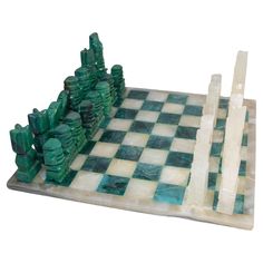 a marble chess set with green and white pieces