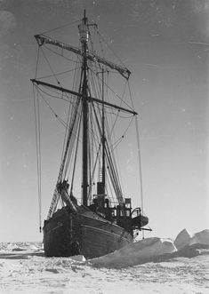 an old ship in the water with ice floating around