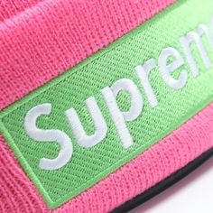 Pink Supreme Beanie New Era, featuring a vibrant pink hue and a striking green embroidered Supreme logo. Elevate your streetwear game with this iconic accessory. Crafted with quality and style in mind, this beanie is a must-have for fashion-forward individuals. Grab yours now! Fabric: 100% cotton One size fit all. Streetwear Beanie With Letter Print, Trendy Letter Print Beanie, Casual Cotton Beanie With Embroidered Logo, Letter Print Beanie For Streetwear, Trendy Beanie For Streetwear, Trendy Pink Cotton Beanie, Streetwear Beanie With Logo Patch, Trendy Beanie With Embroidered Logo, Trendy Beanie For Spring Streetwear