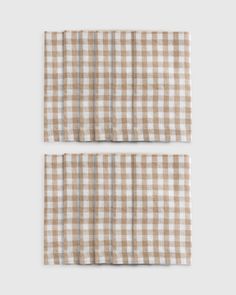 two brown and white checkered napkins on top of each other