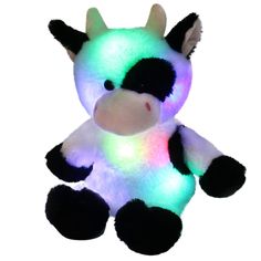 a light up cow sitting on top of a white surface