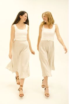 Our Brulé Beige Silk Midi Skirt is perfect for every season. Pair it with a tank or short-sleeve shirt during the spring and summer months, and a long sleeve shirt or sweater during the fall and winter months. This skirt makes any outfit look timeless, feminine, and romantic! Straight Midi Skirt, Silk Midi Skirt, Beige Silk, Fall And Winter, Lightweight Fabric, The Fall, Midi Skirt, Long Sleeve Shirts, Elastic