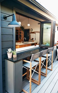 an outdoor kitchen and bar area on a deck