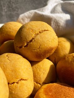 a bowl filled with baked goods sitting on top of a white cloth covered tablecloth