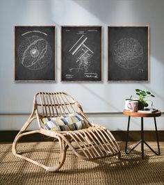 three posters on the wall above a chair and table