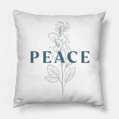 a white pillow with the word peace printed on it and a green plant in the middle