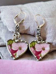 These charming heart earrings were handcrafted from broken Royal Standard, Virginia Stock, chintz china and recycled into earrings. The china earrings are decoratively soldered with a lead free silver alloy solder and are suspended from sterling silver 11.5 x 5mm filigree scroll link and sterling silver shell lever backs.  The earrings dangle 1 1/2 of an inch in length. The china earrings measures 3/4inches wide.  Your jewelry will come in a gift box ready to give or keep for yourself.  Matching Vintage Handmade Dangle Heart Earrings, Vintage Handmade Heart Dangle Earrings, Whimsical Nickel-free Heart Earrings, Handmade Vintage Heart Earrings, Vintage Handmade Heart Earrings For Valentine's Day, Handmade Vintage Heart Earrings For Valentine's Day, China Earrings, Chintz China, Soldered Jewelry