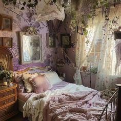 a bedroom decorated in pink and white with flowers on the walls, bedding and curtains