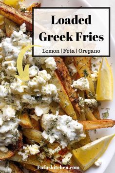 loaded greek fries with lemon, feta and oregano on a white platter