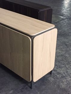 two wooden cabinets sitting on top of a cement floor