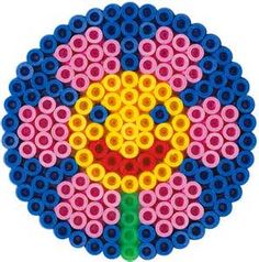 a flower made out of legos sitting in the middle of a circle on a white background